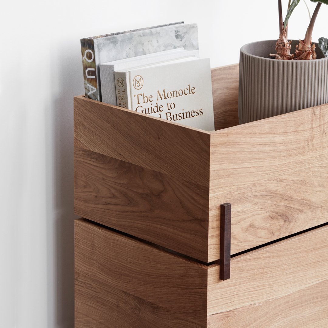 Natural wood grain with light brown tones, featuring clean lines and a modern design; accents with gray plant pot.