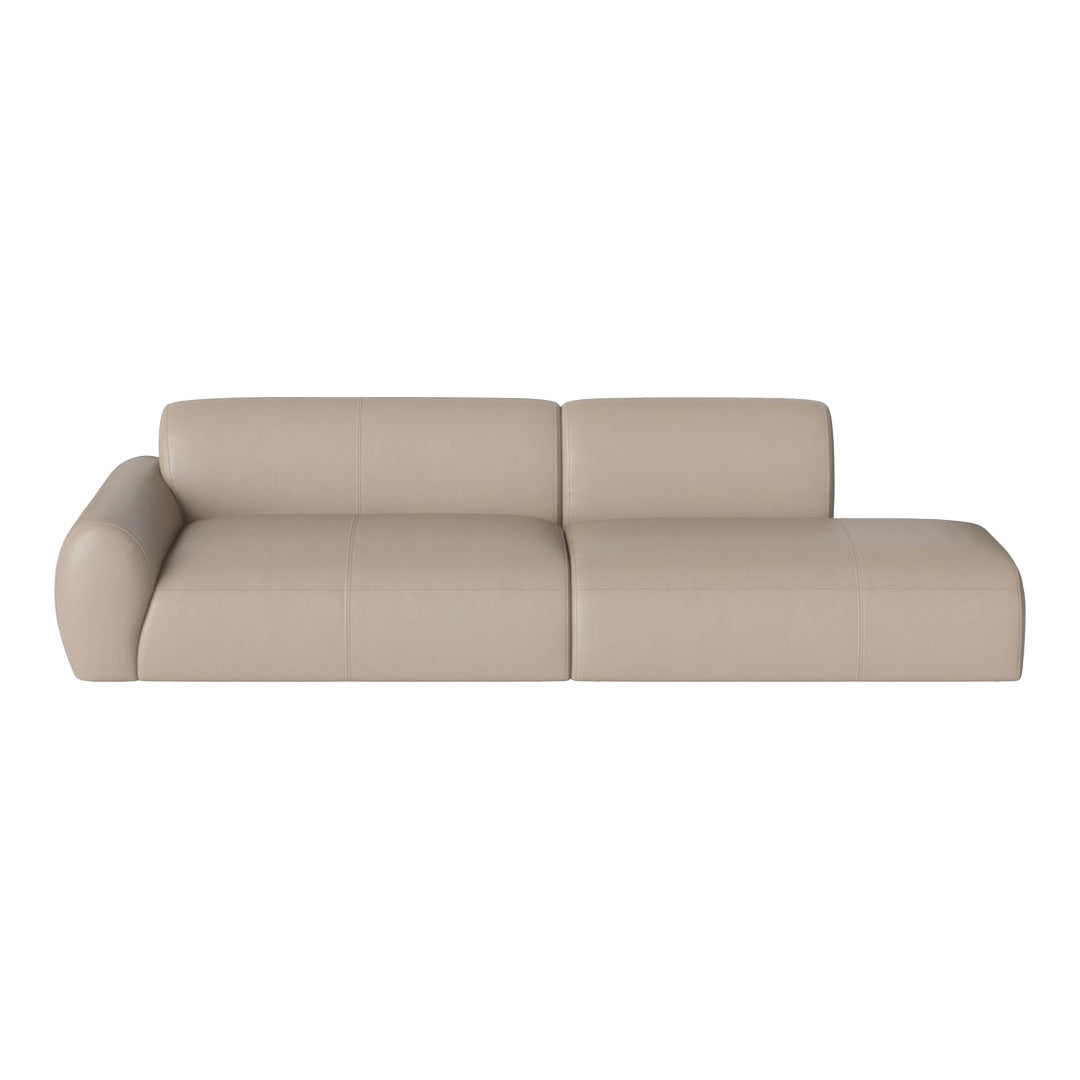 Beige leather sectional sofa with smooth surface and minimalist design, perfect for modern interiors.