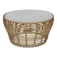 Round basket weave coffee table with a natural bamboo base and smooth gray stone top. Perfect for rustic decor.