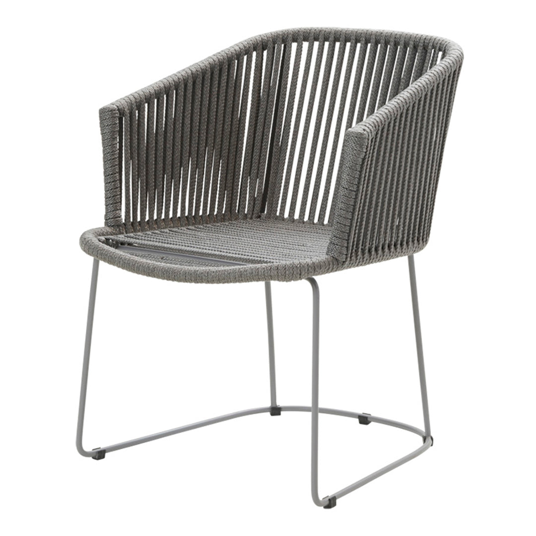 Gray woven chair with a modern ribbed pattern and sleek metal frame, perfect for contemporary decor.