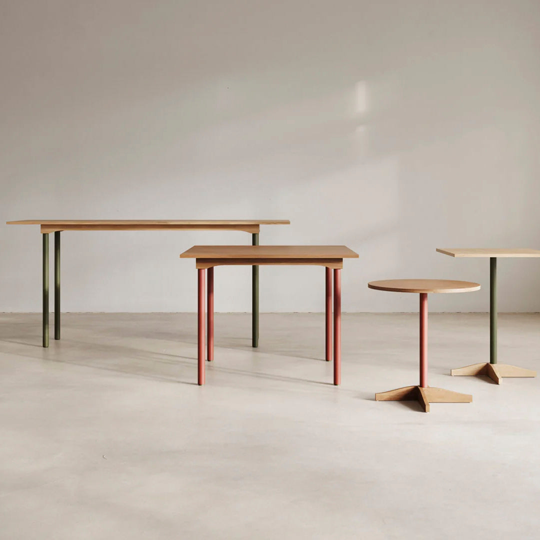 "Wooden tables with minimalist design, featuring earthy tones of brown, green, and red legs, modern geometric shapes."