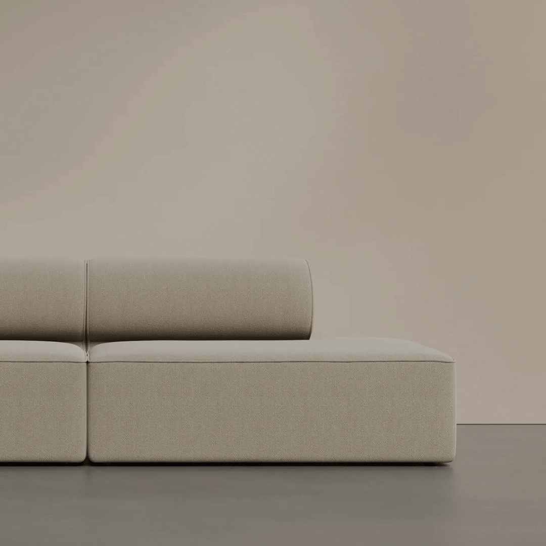 Beige modern sofa with a smooth texture against a soft, neutral background. Stylish and minimalist design.
