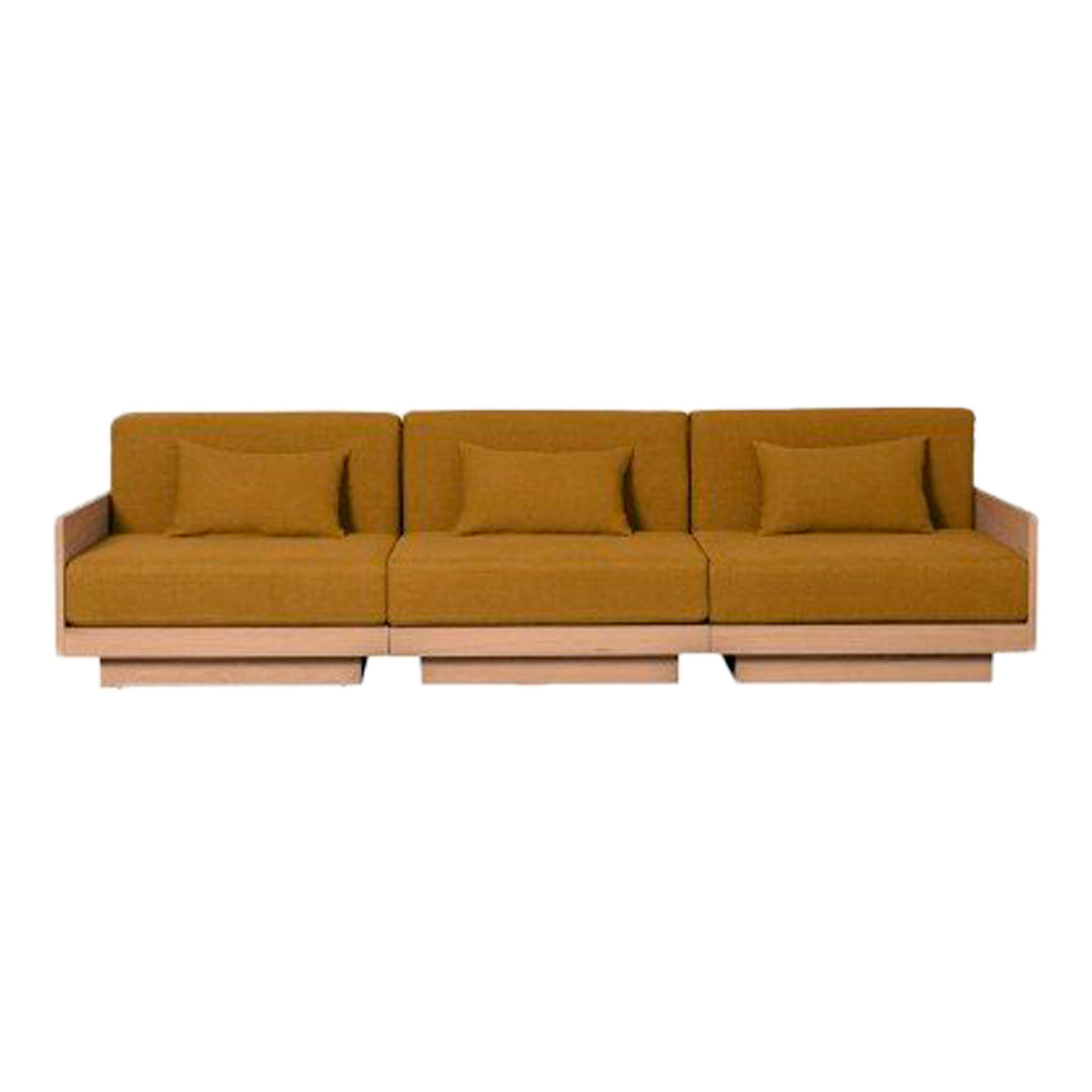 Modern three-seat sofa in warm mustard yellow upholstery with simple, elegant lines and plush cushions.