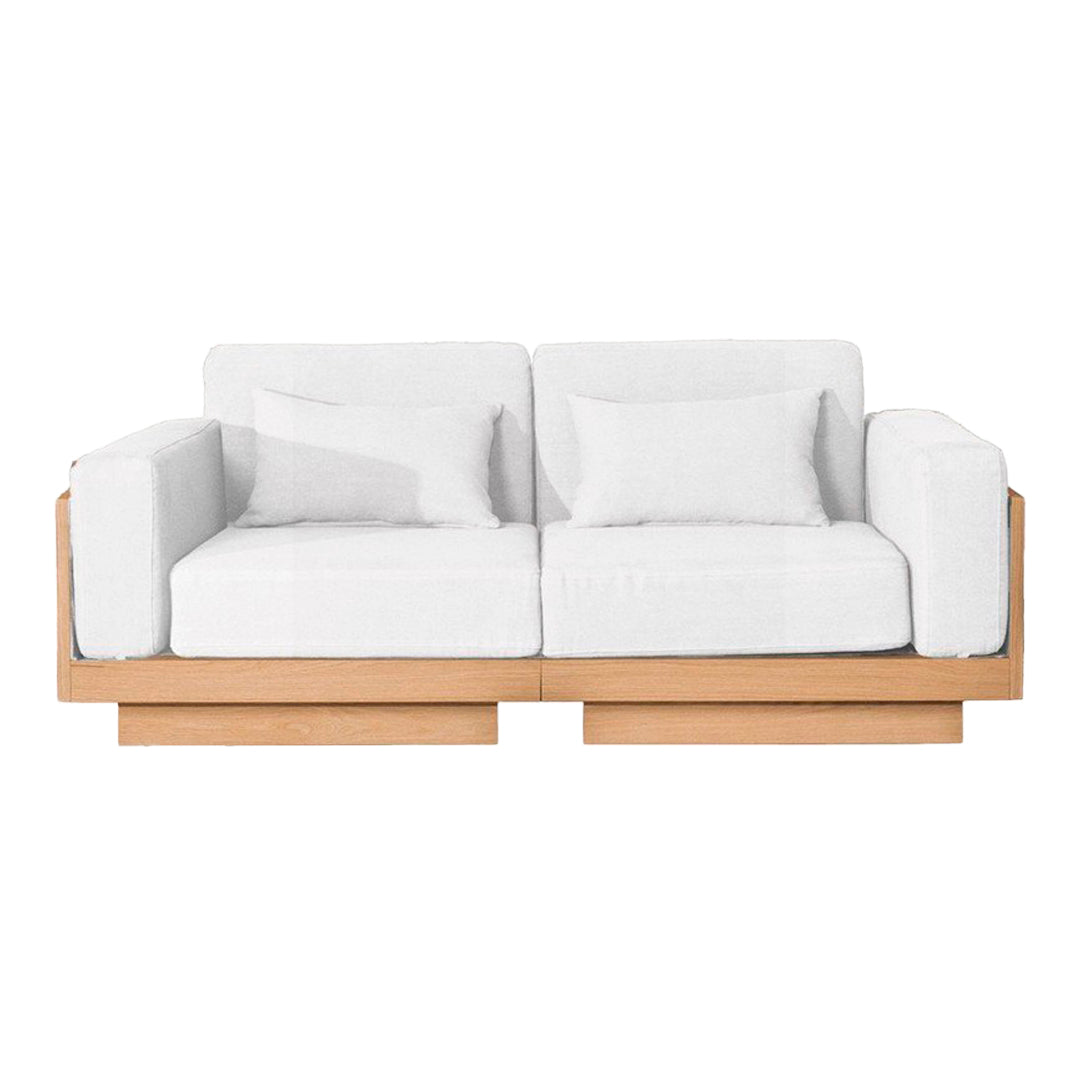 White upholstered sofa with a minimalist design and natural wood frame, featuring clean lines and modern aesthetics.