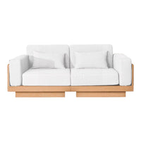 White upholstered sofa with a minimalist design and natural wood frame, featuring clean lines and modern aesthetics.