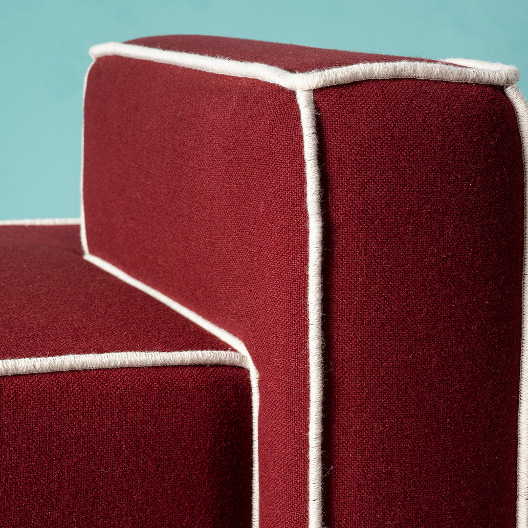 Burgundy upholstery with contrasting white trim, showcasing a modern, geometric design.