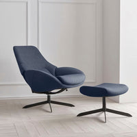Modern navy blue accent chair and ottoman, featuring sleek lines and a minimalist design, set against a light backdrop.