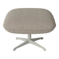 Light grey ribbed ottoman with a smooth texture and white metal base, perfect for modern decor.