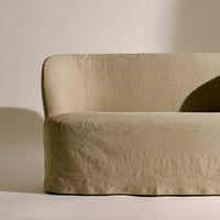 Beige, textured fabric sofa with a minimalist design and soft, curved edges. Ideal for modern interior decor.