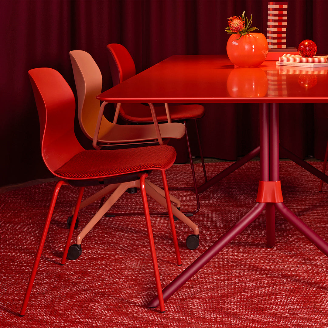 "Vibrant red dining set featuring patterned chairs and accessories in varying shades of red and warm beige tones."