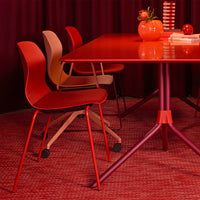 "Vibrant red dining set featuring patterned chairs and accessories in varying shades of red and warm beige tones."