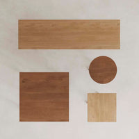 Natural wood tabletop collection featuring various shapes in warm tones and smooth, light textures.