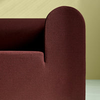Burgundy textured fabric with a smooth curved edge against a soft beige background.