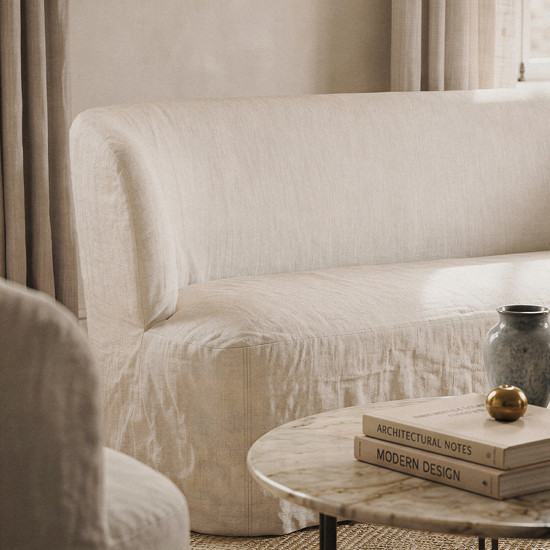 Cream-colored textured sofa with soft, muted tones and subtle patterns, enhancing a minimalist decor aesthetic.