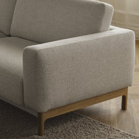 Light gray textured upholstery on a modern sofa, featuring a natural wood base for a minimalist look.