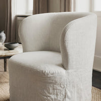 Light gray upholstered chair with a smooth, minimalist design and rounded back for a modern aesthetic.