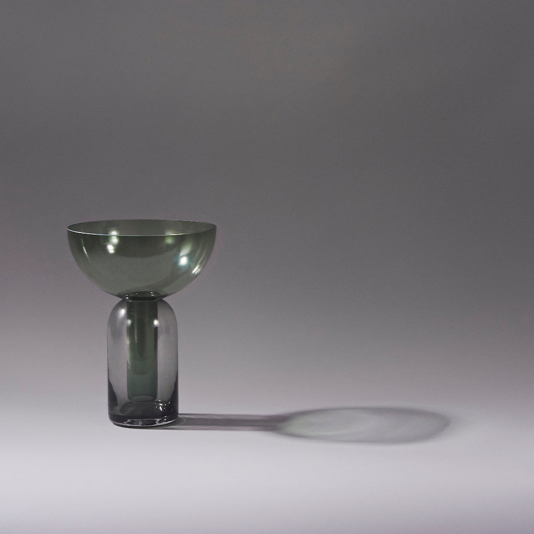 Smoke green glass vase with a rounded bowl top and cylindrical base, creating a sleek, modern design.