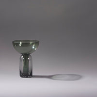 Smoke green glass vase with a rounded bowl top and cylindrical base, creating a sleek, modern design.