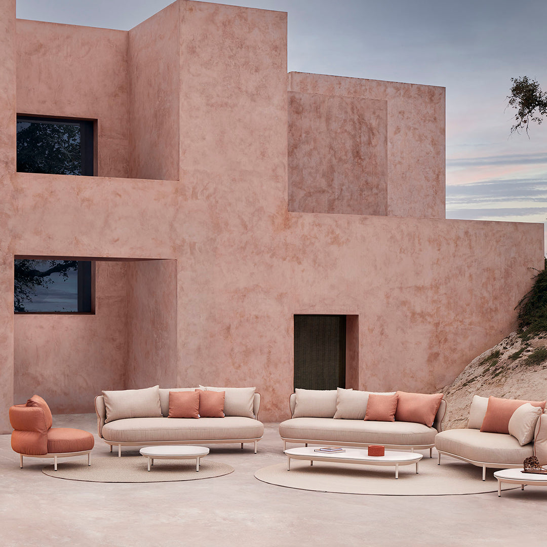 "Modern light pink sofa set with soft coral cushions, paired with a minimalist design and warm neutral tones."