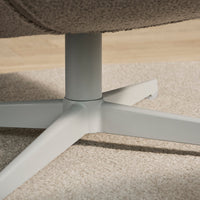 Sleek light gray metal base on soft beige carpet with textured tan fabric details. Modern design meets comfort.