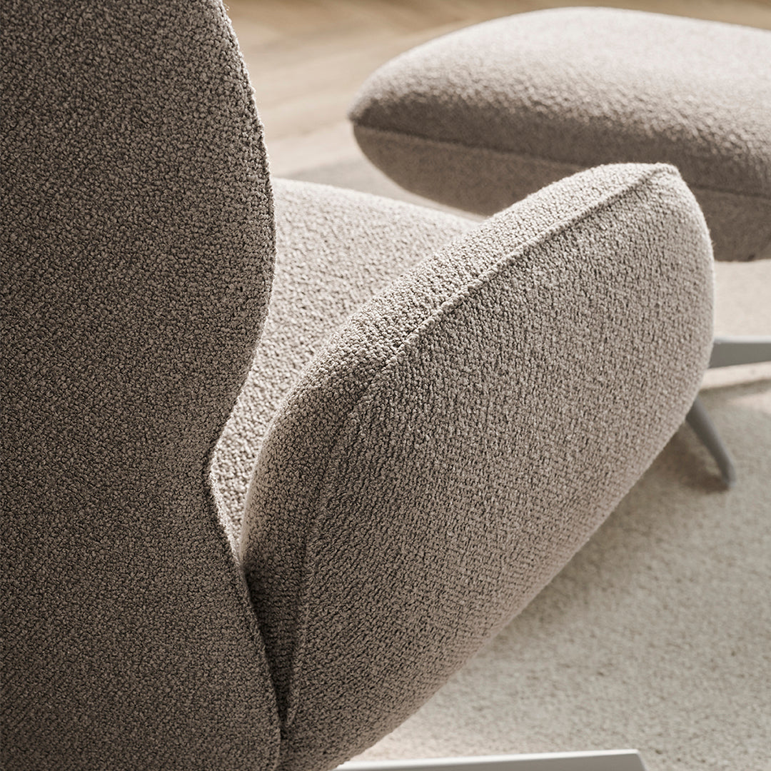 Textured taupe upholstery with plush, rounded shapes enhancing modern design and comfort.