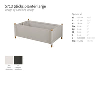 Large Sticks planter in soft gray with black accents and natural wood legs, featuring a minimalistic design.