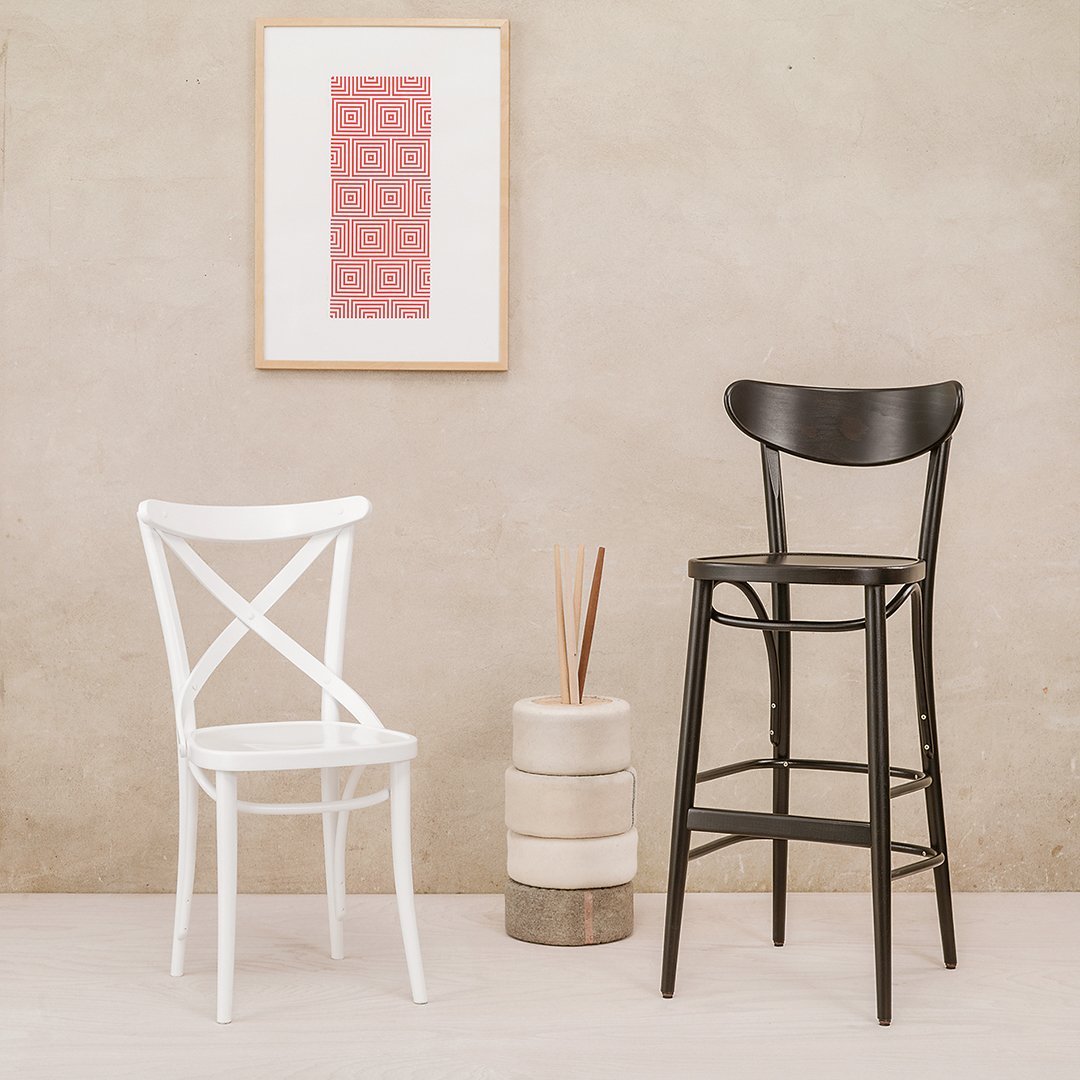 "Stylish black and white bar stools with a minimalistic pattern against a neutral backdrop."