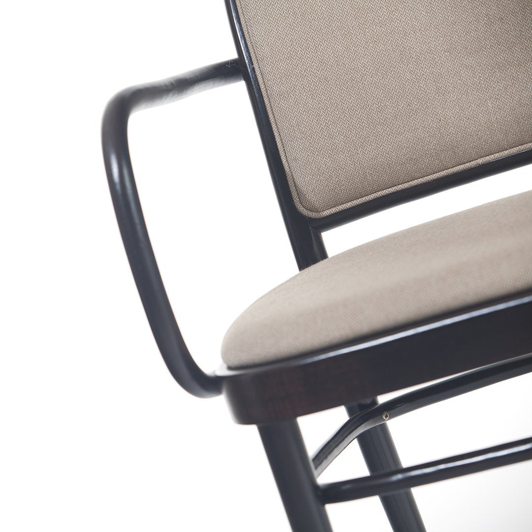 Beige upholstered seat and backrest with black metal frame, showcasing a modern minimalist design.