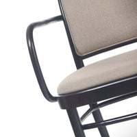 Beige upholstered seat and backrest with black metal frame, showcasing a modern minimalist design.