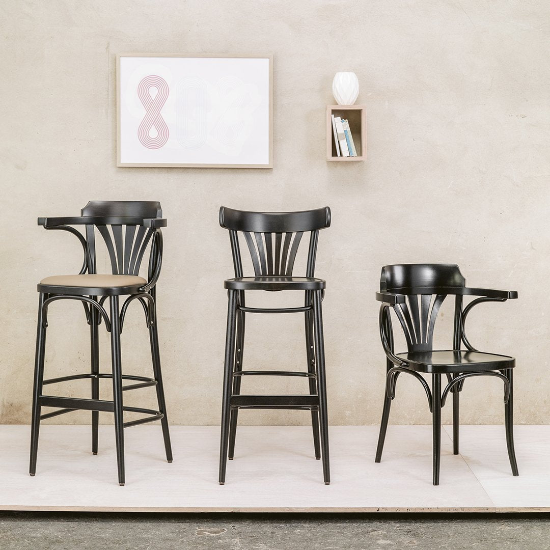"Set of three stylish black wooden bar stools with sleek curves, perfect for contemporary decor."