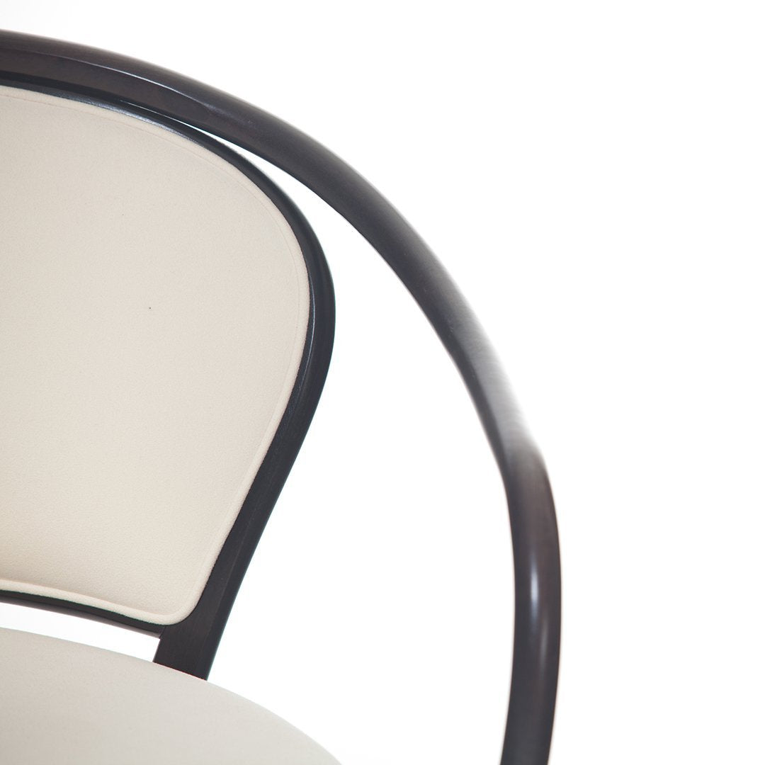 Modern beige chair with a sleek dark wood frame, featuring a smooth, minimalist design. Perfect for any decor.