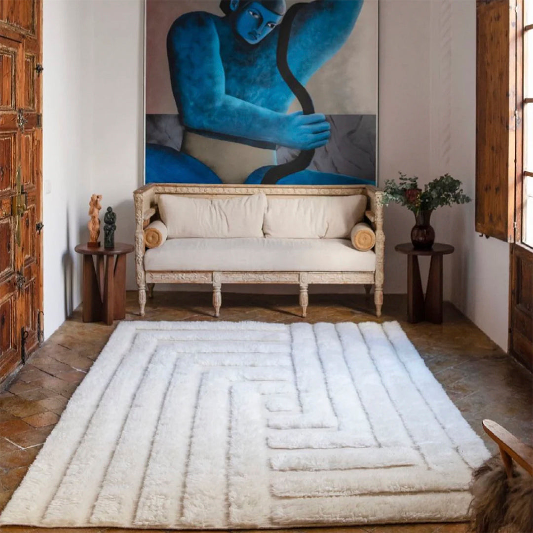 White fluffy geometric rug with subtle textured patterns, enhancing cozy interior decor.