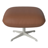 Brown leather ottoman with a smooth texture and minimalist white base, perfect for modern decor.