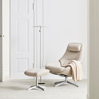 Beige recliner chair with matching ottoman, soft fabric, clean lines, and a neutral, minimalistic aesthetic.