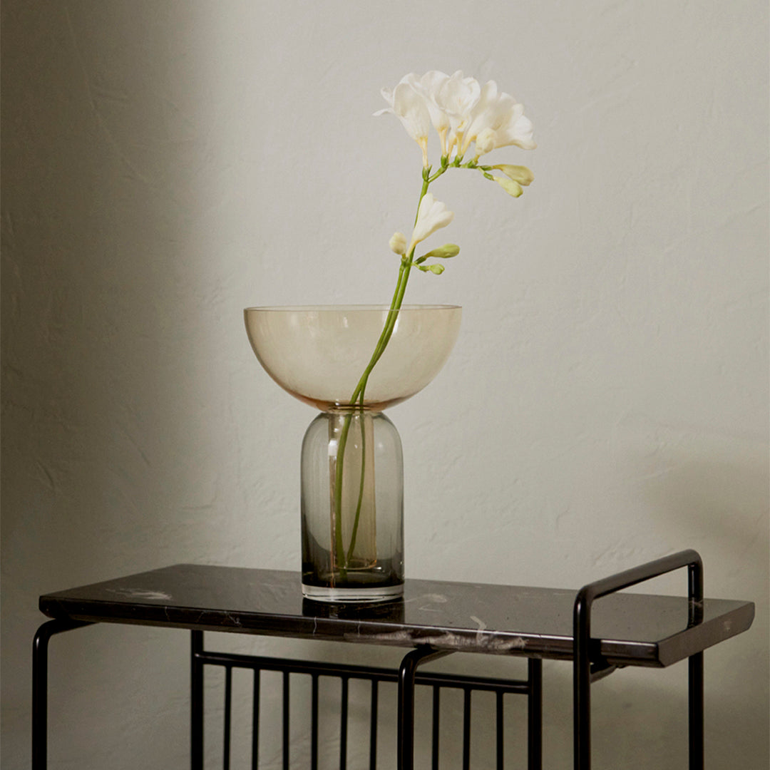 Elegant glass vase in soft beige and smoky gray, featuring a minimalist design and paired with a delicate white flower.