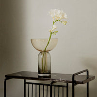 Elegant glass vase in soft beige and smoky gray, featuring a minimalist design and paired with a delicate white flower.