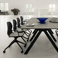 Modern office setup with a black table and chairs, featuring a blue bowl and sleek grey patterns. Clean, minimalist design.