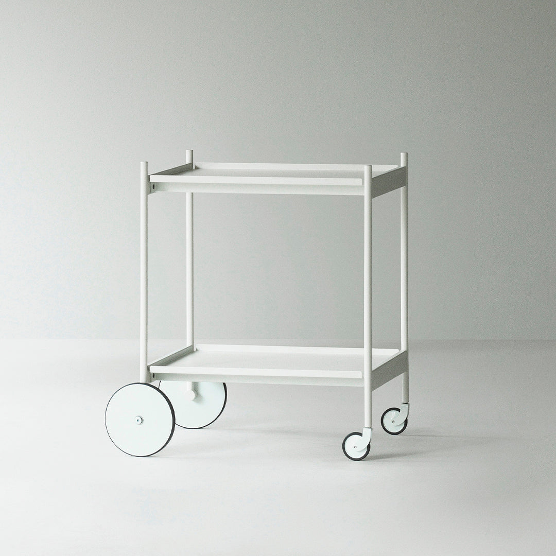 White rolling cart with minimalistic design and round black-accented wheels, perfect for modern decor.