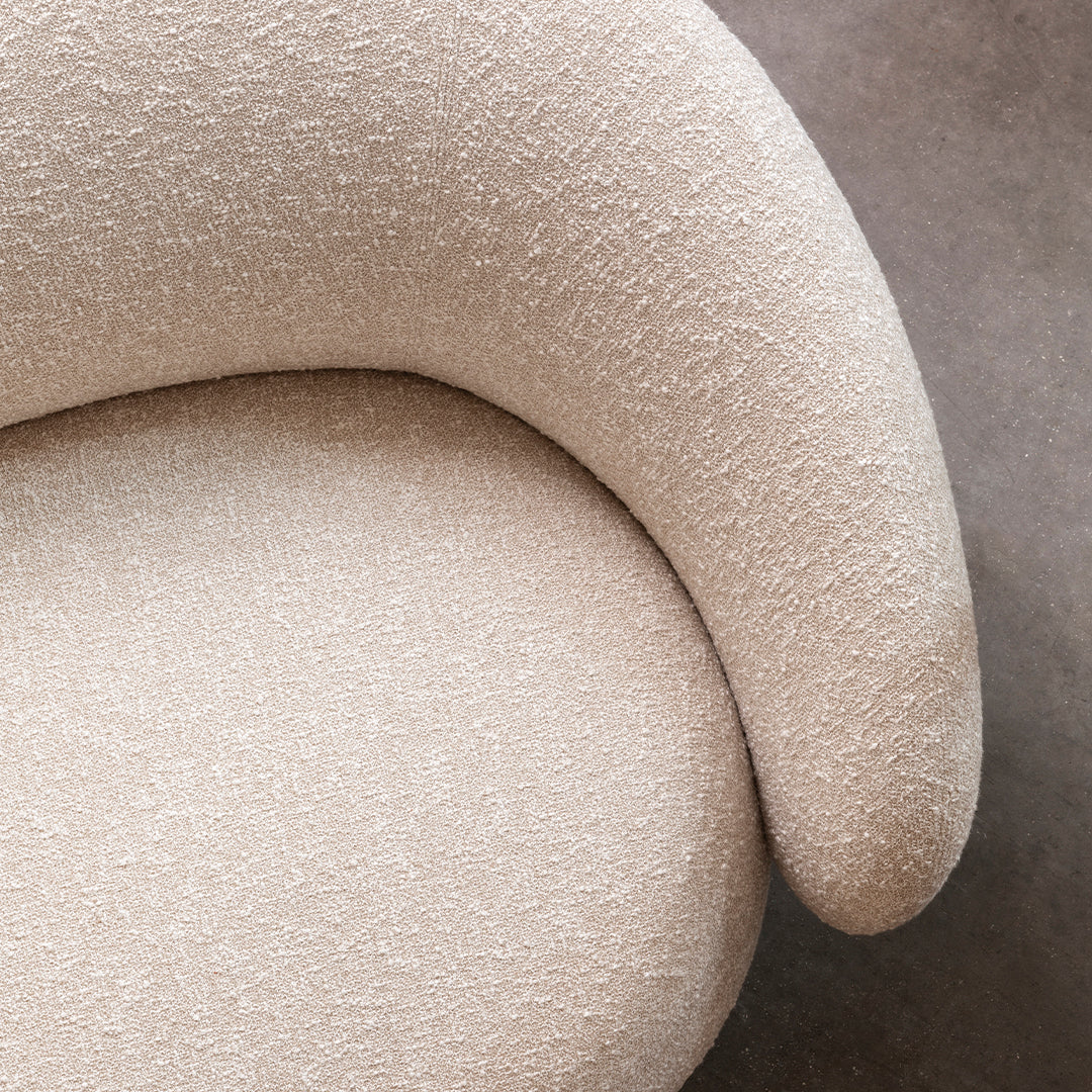 Soft beige textured fabric with a subtle pattern, showcasing a curved, modern design. Ideal for stylish home decor.