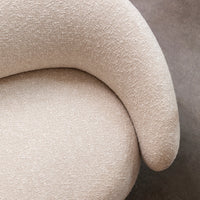 Soft beige textured fabric with a subtle pattern, showcasing a curved, modern design. Ideal for stylish home decor.