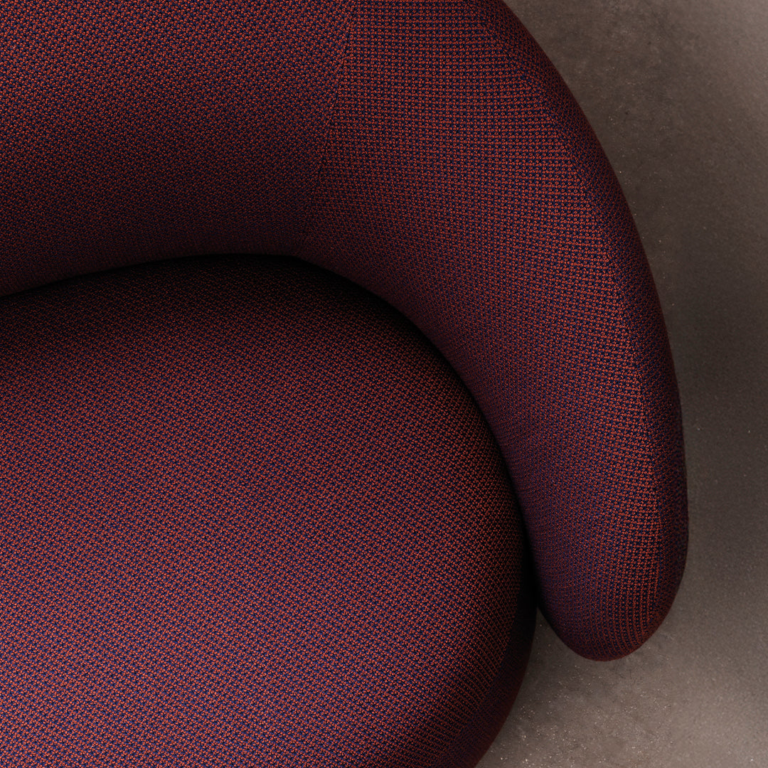 Textured upholstery in deep burgundy and subtle purple, showcasing a modern, stylish pattern.