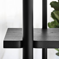 Black wood shelf with smooth texture and minimalistic design, featuring sleek lines and a contemporary aesthetic.