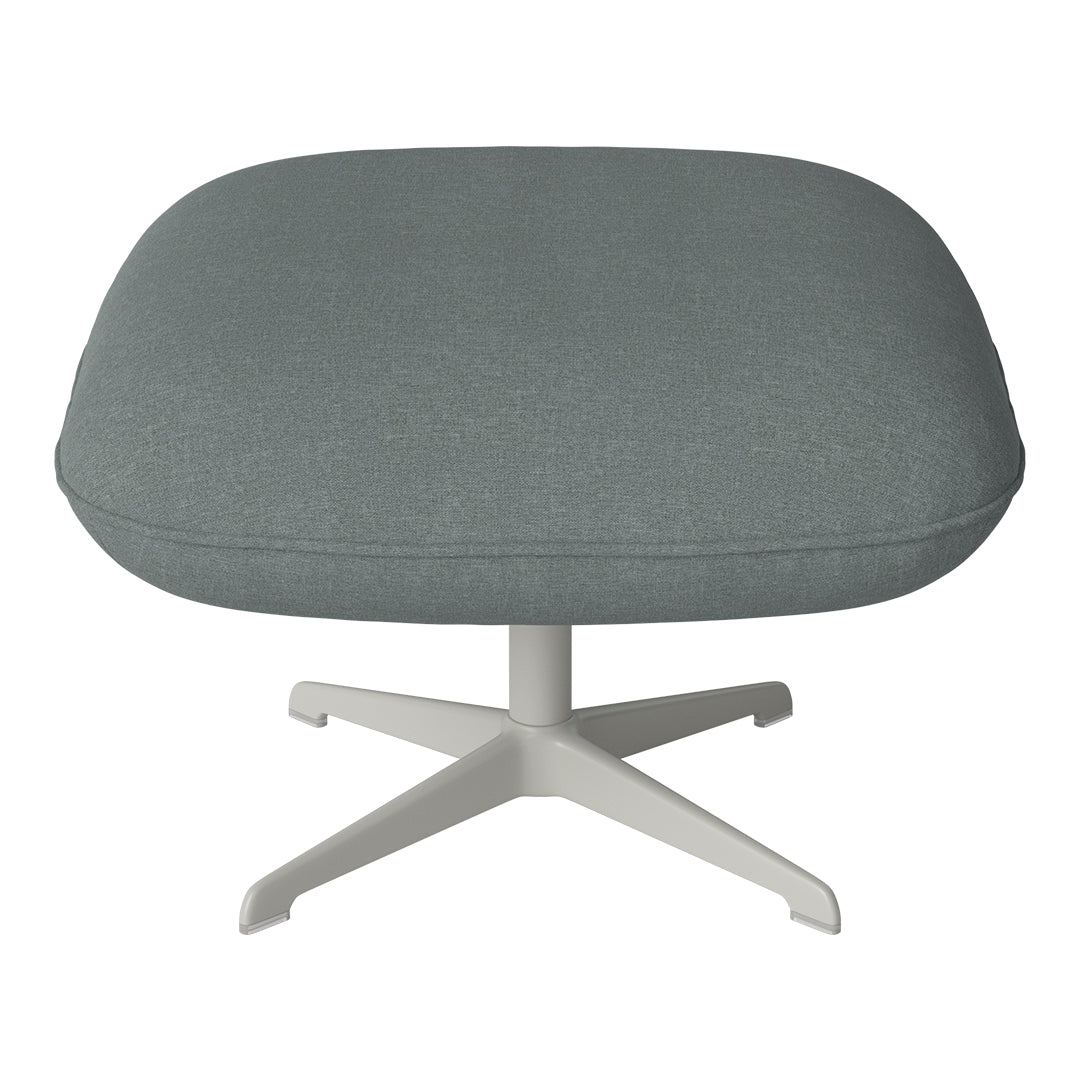 Soft grey upholstery on a round, padded ottoman with a sleek white base, perfect for modern decor.