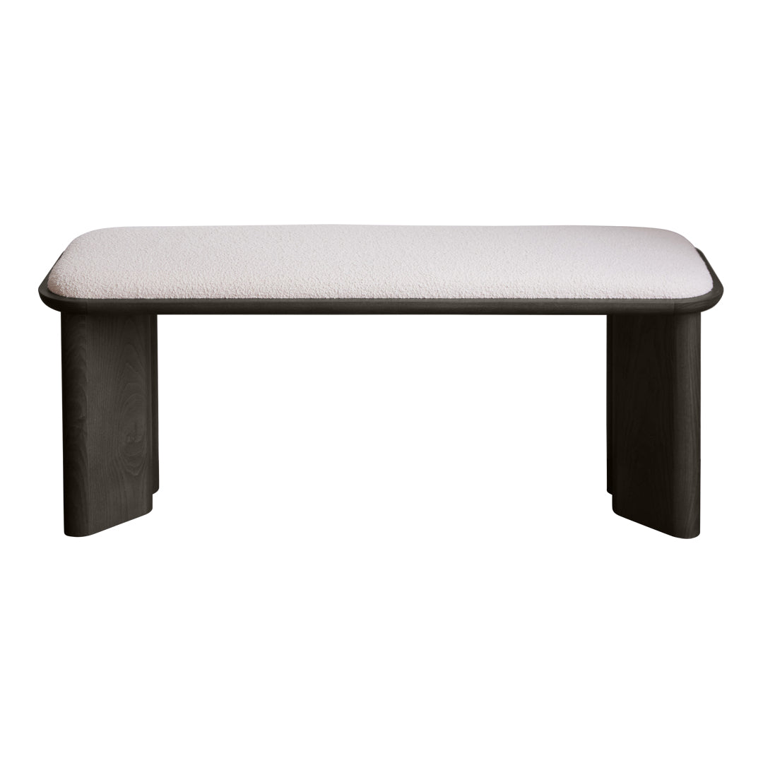 Gray upholstered bench with rounded edges and dark wood legs, featuring a minimalistic design suitable for modern decor.