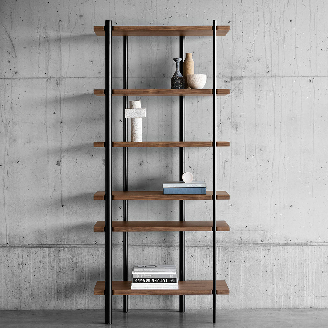 Wooden shelves with a warm brown finish and black metal frame, set against a sleek concrete backdrop.