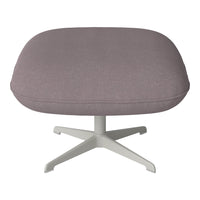 Gray upholstered ottoman with a smooth texture and minimalist white base, perfect for modern decor.