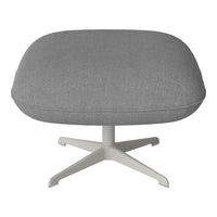 Gray upholstered ottoman with a soft texture and modern white base, ideal for contemporary decor.