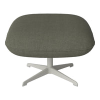 Olive green upholstered ottoman with a smooth, textured fabric resting on a white, star-shaped base.