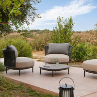 Modern outdoor seating in neutral beige and gray tones, featuring sleek black accents and minimalist patterns.