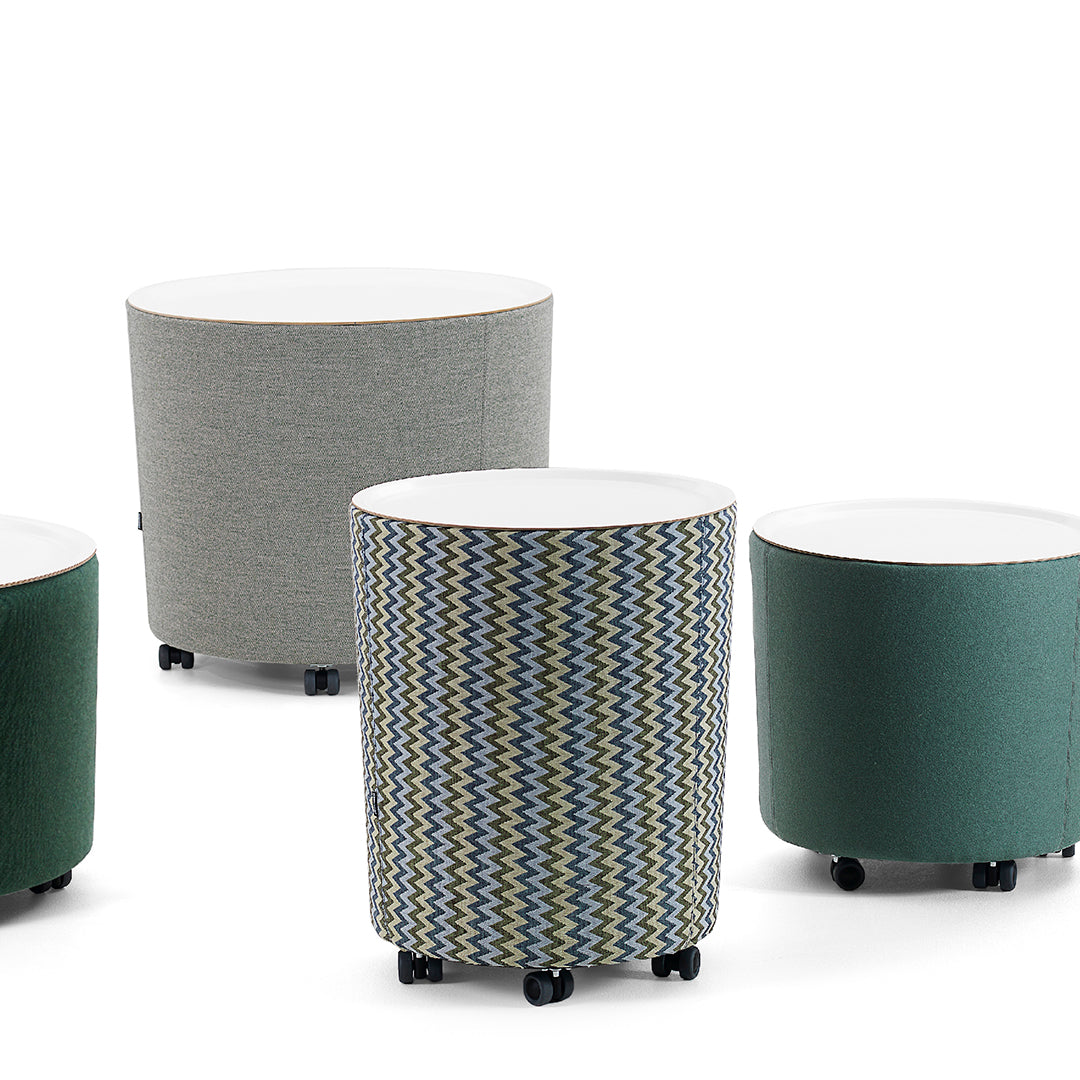 Colorful round storage tables featuring gray, green, and a zigzag patterned fabric. Perfect for modern decor.